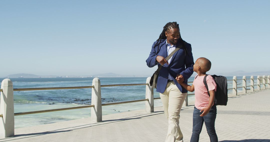 Father and Son Enjoy Walk by Sea's Edge