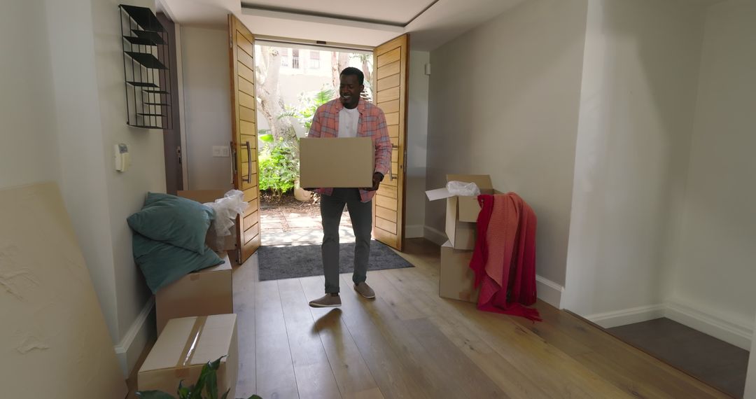 Man Carrying Boxes in Modern Home Entranceway