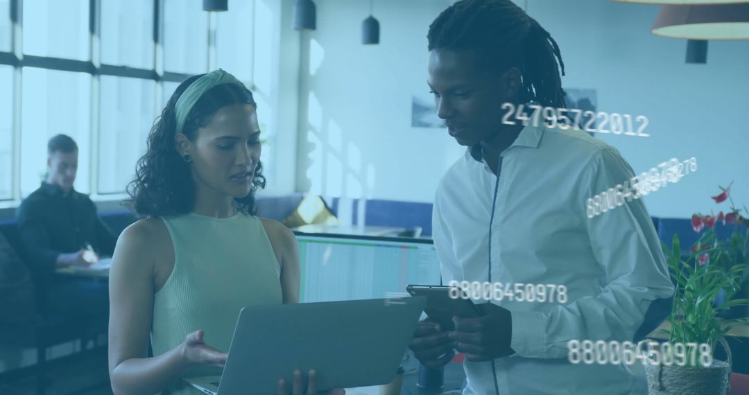 Diverse Colleagues Collaborating on Digital Data in Modern Office