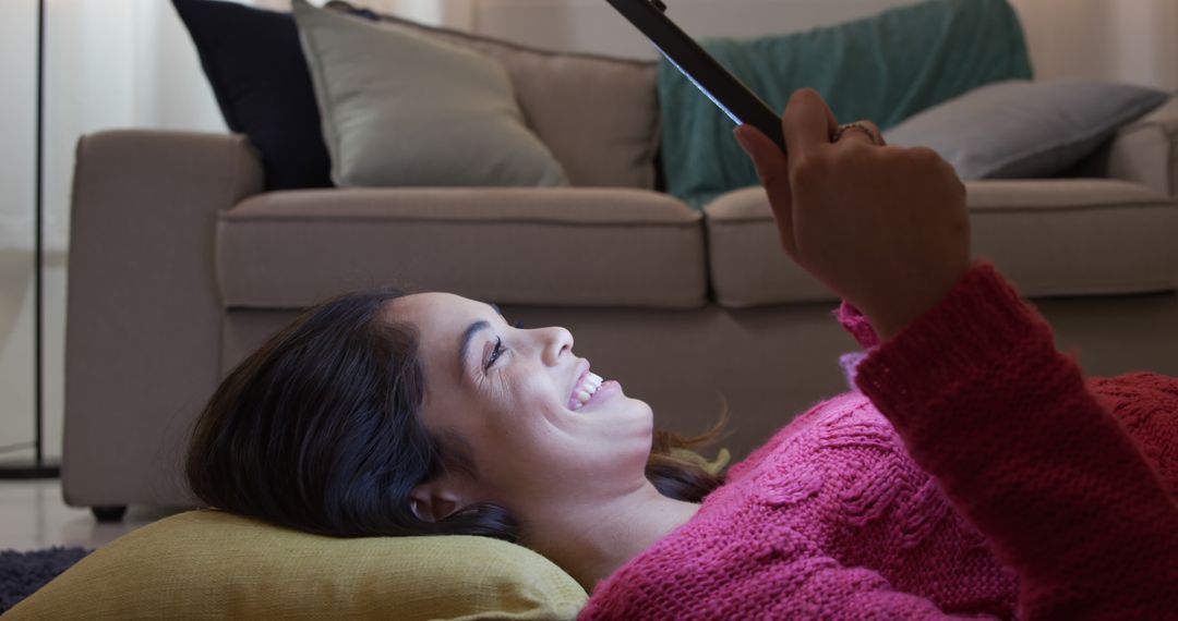 Smiling Young Woman Using Tablet at Home on Cozy Evening - Free Images, Stock Photos and Pictures on Pikwizard.com