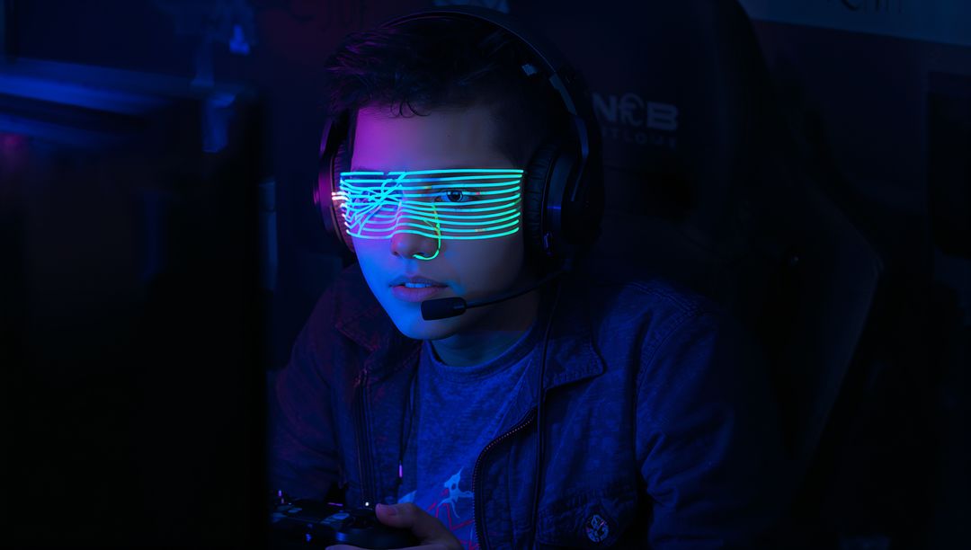 Young Gamer Wearing LED Shutter Glasses Playing Controller in Neon Esports Streaming Setup