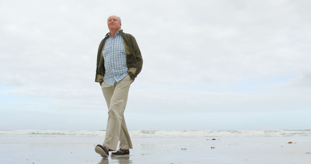 Senior Man Walking on Beach, Enjoying Leisurely Stroll - Free Images, Stock Photos and Pictures on Pikwizard.com