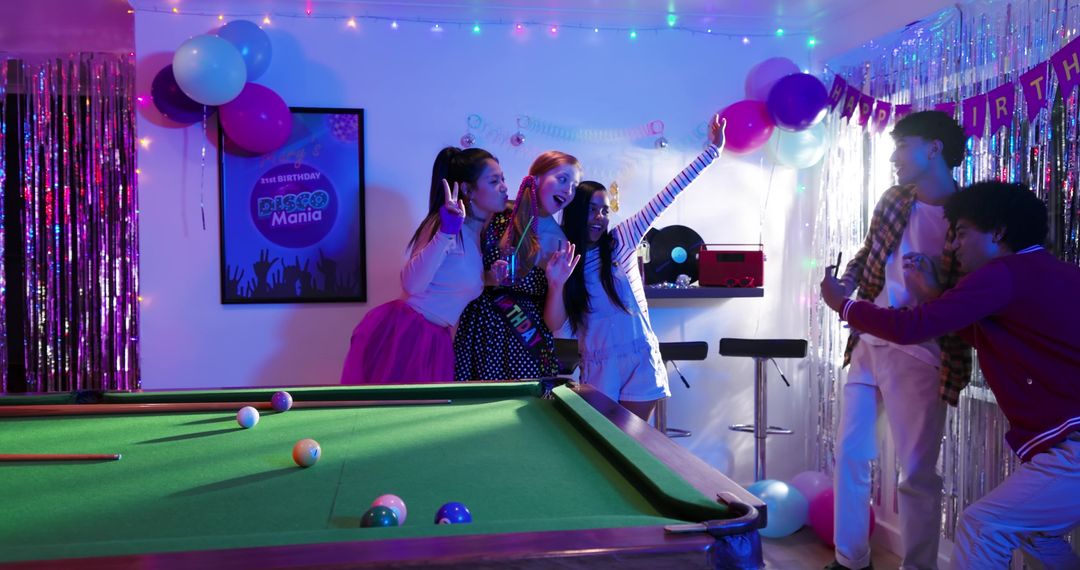 Friends Posing by Pool Table Celebrating Birthday with Neon Disco Retro Party Vibes
