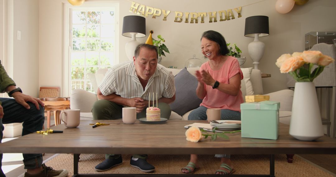 Diverse seniors celebrating birthday with cake and gifts