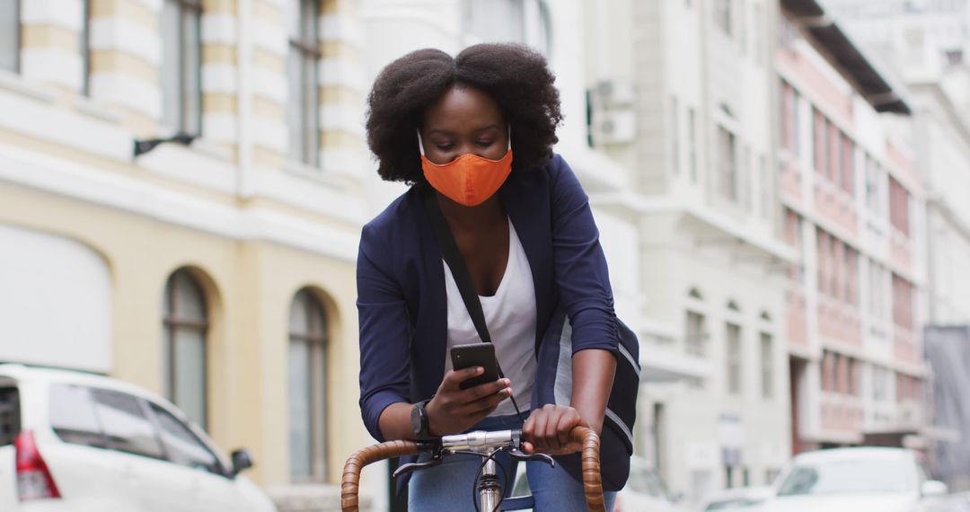 Urban Cyclist Wearing Mask Using Smartphone Pandemic Safety - Free Images, Stock Photos and Pictures on Pikwizard.com