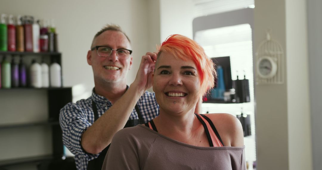 Hairdresser styling woman's vibrant dyed hair in salon - Free Images, Stock Photos and Pictures on Pikwizard.com