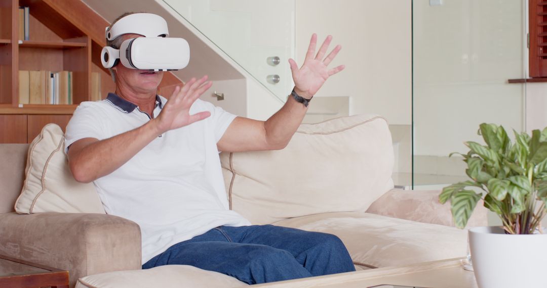 Senior Man Experiencing Virtual Reality Comfortably on Sofa