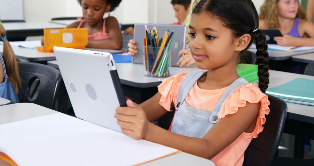 Young Girl Using Tablet During Class in Modern Classroom - Free Images, Stock Photos and Pictures on Pikwizard.com