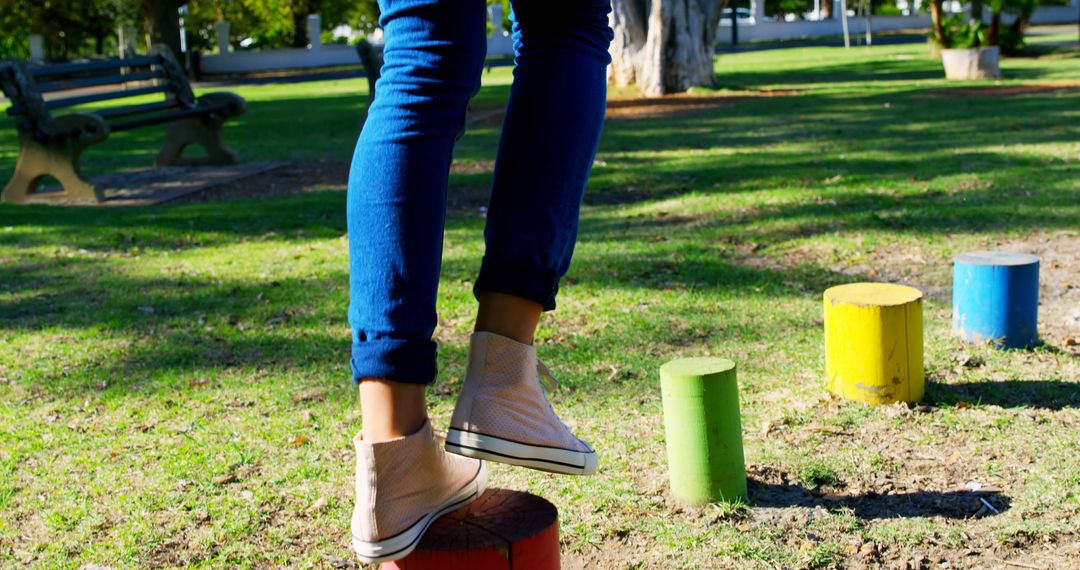 Child Balancing on Colorful Stumps in Play Area - Free Images, Stock Photos and Pictures on Pikwizard.com