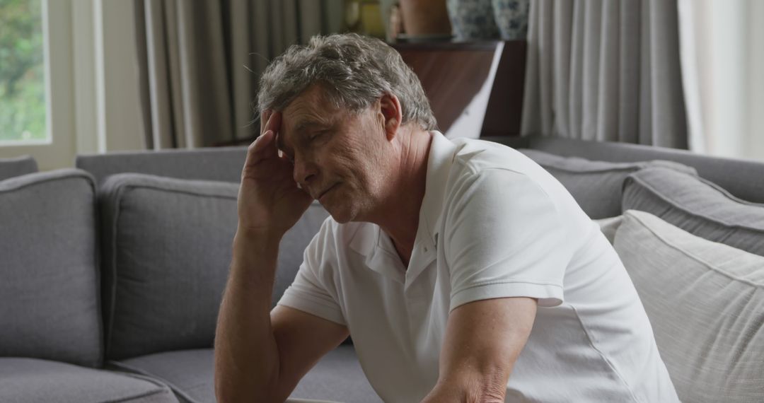 Senior Man Overwhelmed with Stress in Living Room - Free Images, Stock Photos and Pictures on Pikwizard.com