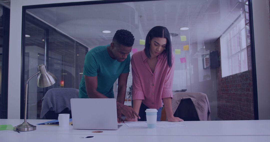 Diverse Coworkers Collaborating on Project in Modern Office Environment