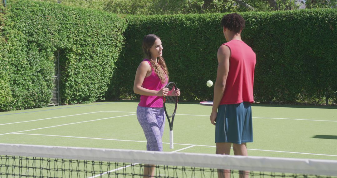 Young Couple Enjoying Recreational Tennis Match on Sunny Day Outdoors - Free Images, Stock Photos and Pictures on Pikwizard.com