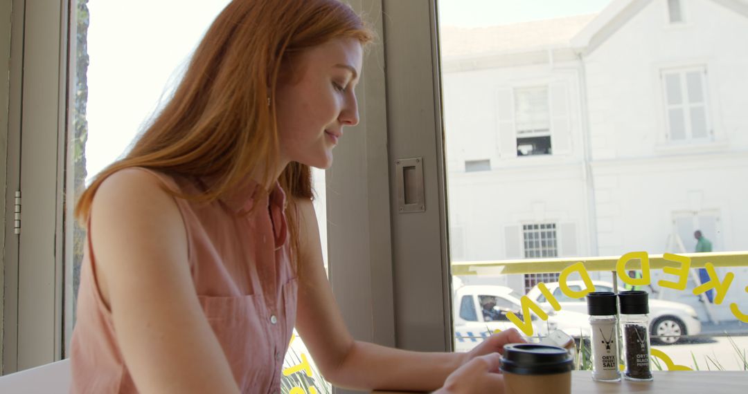 Young woman enjoying coffee in modern cafe - Free Images, Stock Photos and Pictures on Pikwizard.com