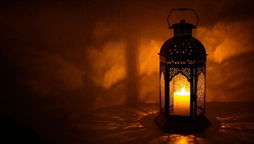 Ornate Filigree Lantern Casting Warm Patterned Shadows With Glowing Pillar Candle