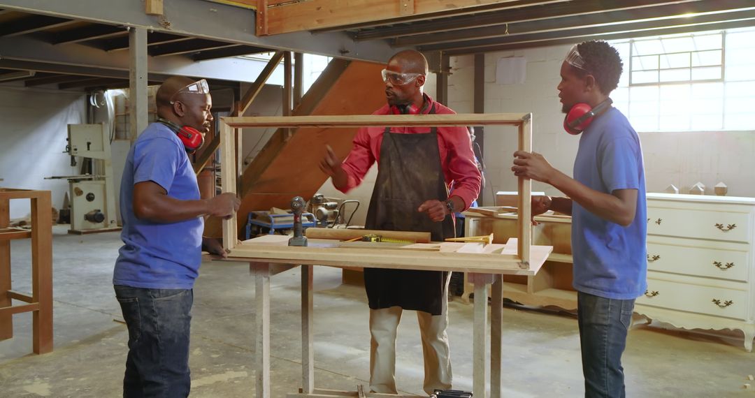 Team Collaboration in Woodworking Workshop with Wooden Frame Assembly