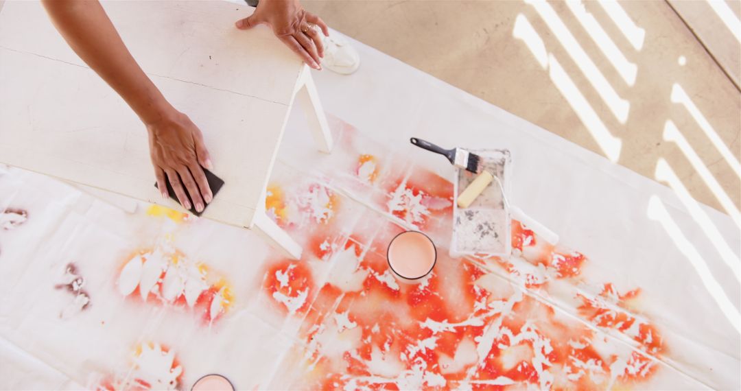 Artists at Work with Paint and Brush on Floor Canvas