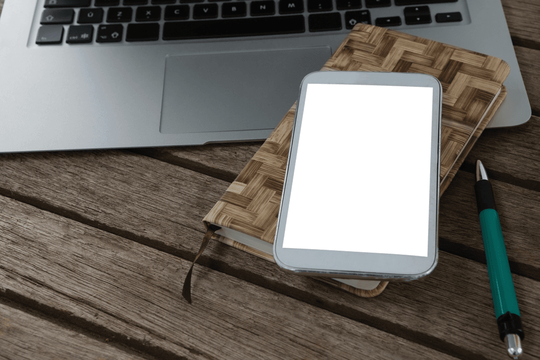 Transparent Mobile Phone on Notebook with Laptop on Wooden Table