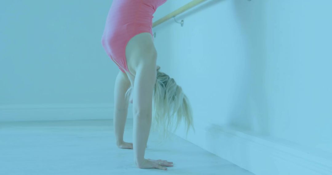 Female Dancer Handstand in Ballet Studio Showing Flexibility