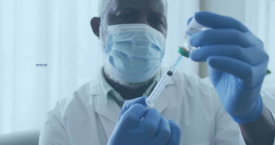 Healthcare Worker Drawing Liquid into Syringe for Vaccination