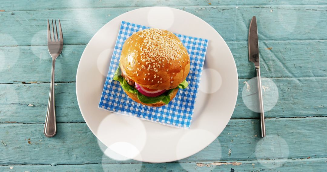 Burger with Sesame Bun on Rustic Table Surrounded by Bokeh - Free Images, Stock Photos and Pictures on Pikwizard.com