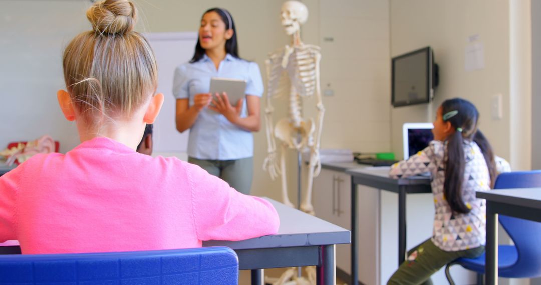 Teacher Explaining Human Anatomy to Students in Classroom