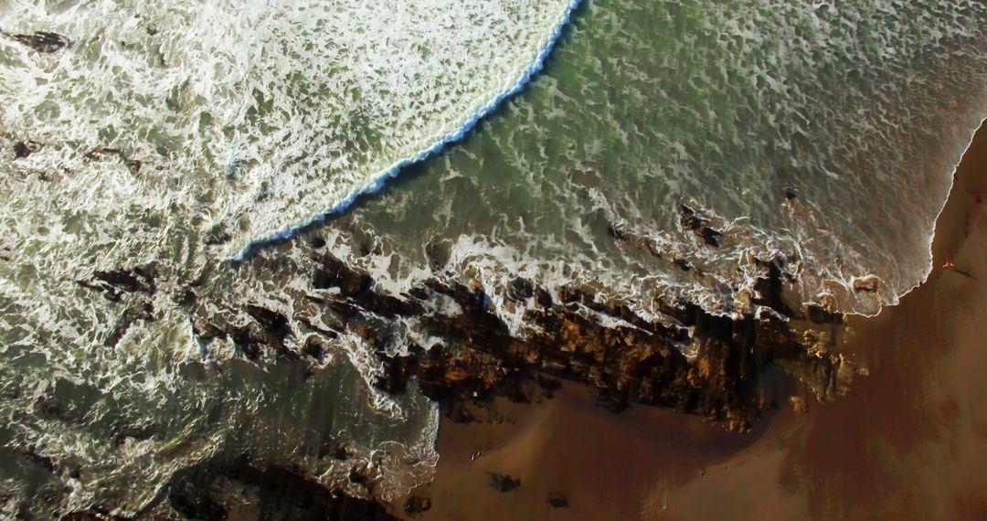 Aerial View of Wave Crashing on Rocky Shoreline at Beach - Free Images, Stock Photos and Pictures on Pikwizard.com