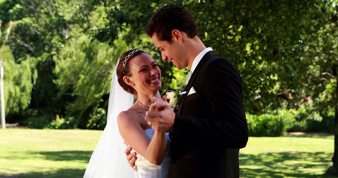 Smiling Bride and Groom Dancing Outdoors on Wedding Day - Free Images, Stock Photos and Pictures on Pikwizard.com