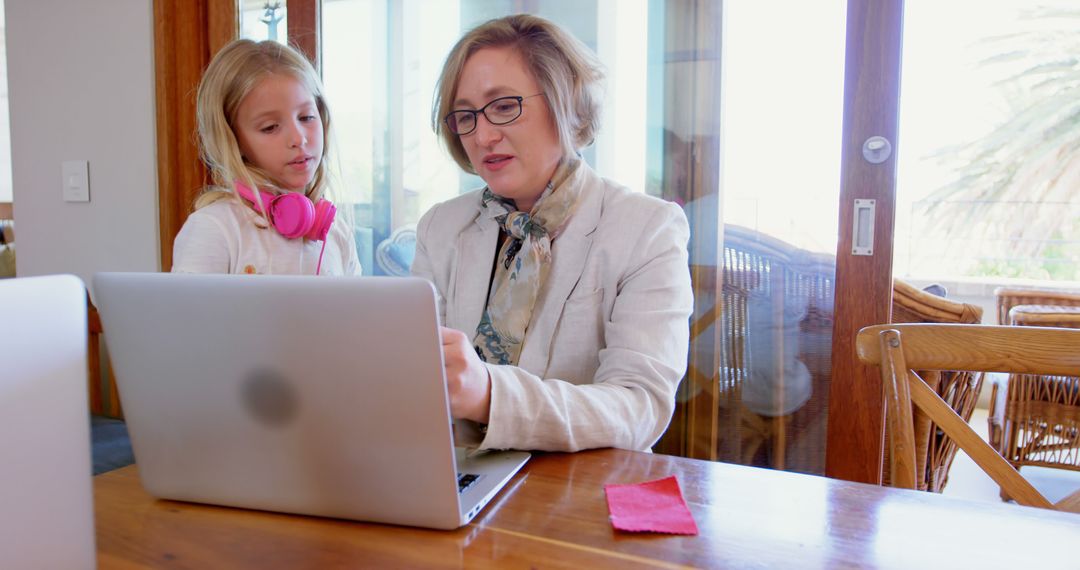 Mother Helping Daughter with Online Schoolwork at Home - Free Images, Stock Photos and Pictures on Pikwizard.com