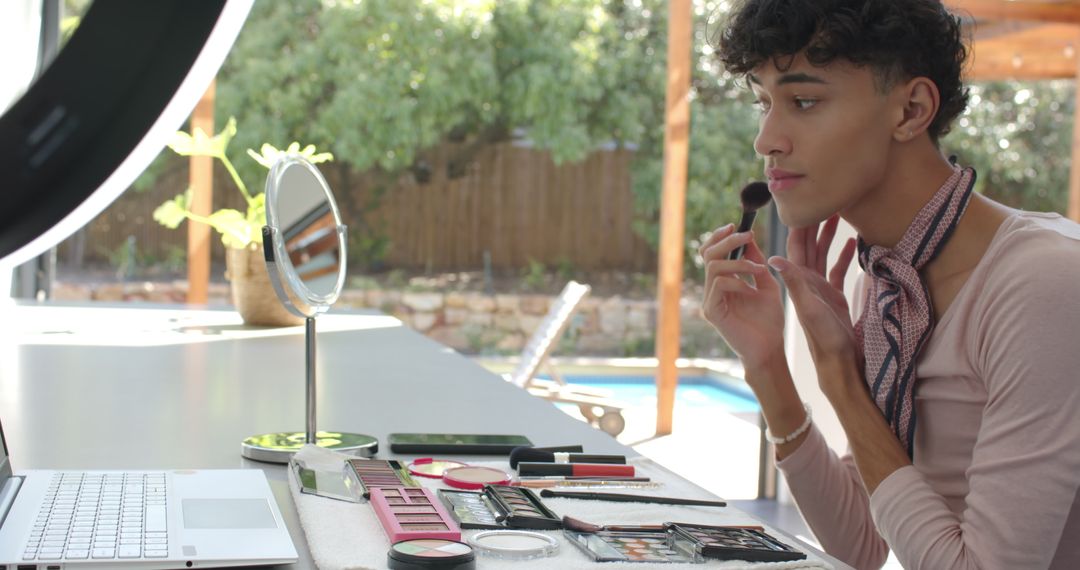 Man Applying Makeup Beside Pool with Ring Light on Patio