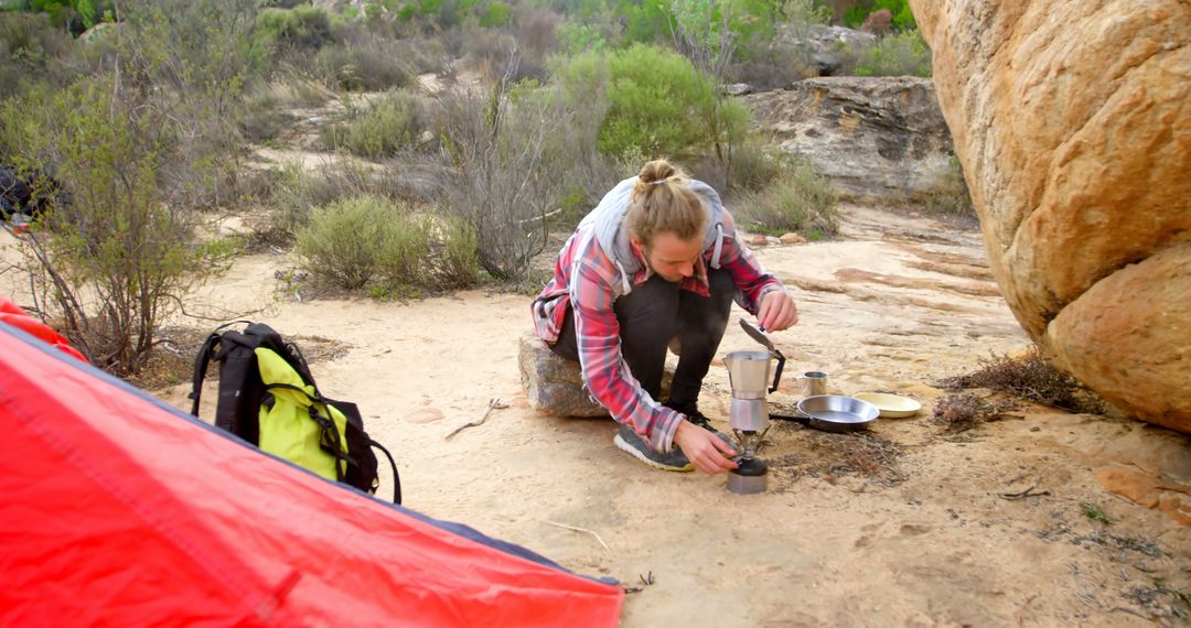 Woman Camping Outdoors Preparing Coffee with Portable Stove - Free Images, Stock Photos and Pictures on Pikwizard.com