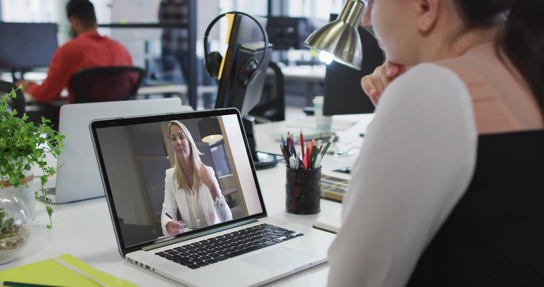Woman Attends Virtual Meeting at Open Office Workspace