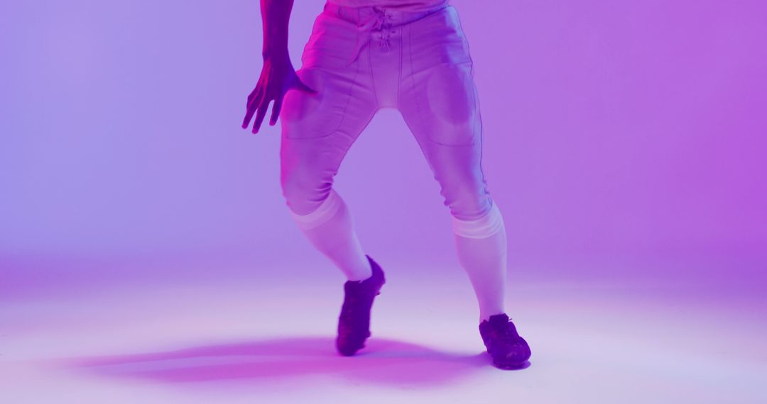 Image of african american american football player with ball over purple background - Free Images, Stock Photos and Pictures on Pikwizard.com
