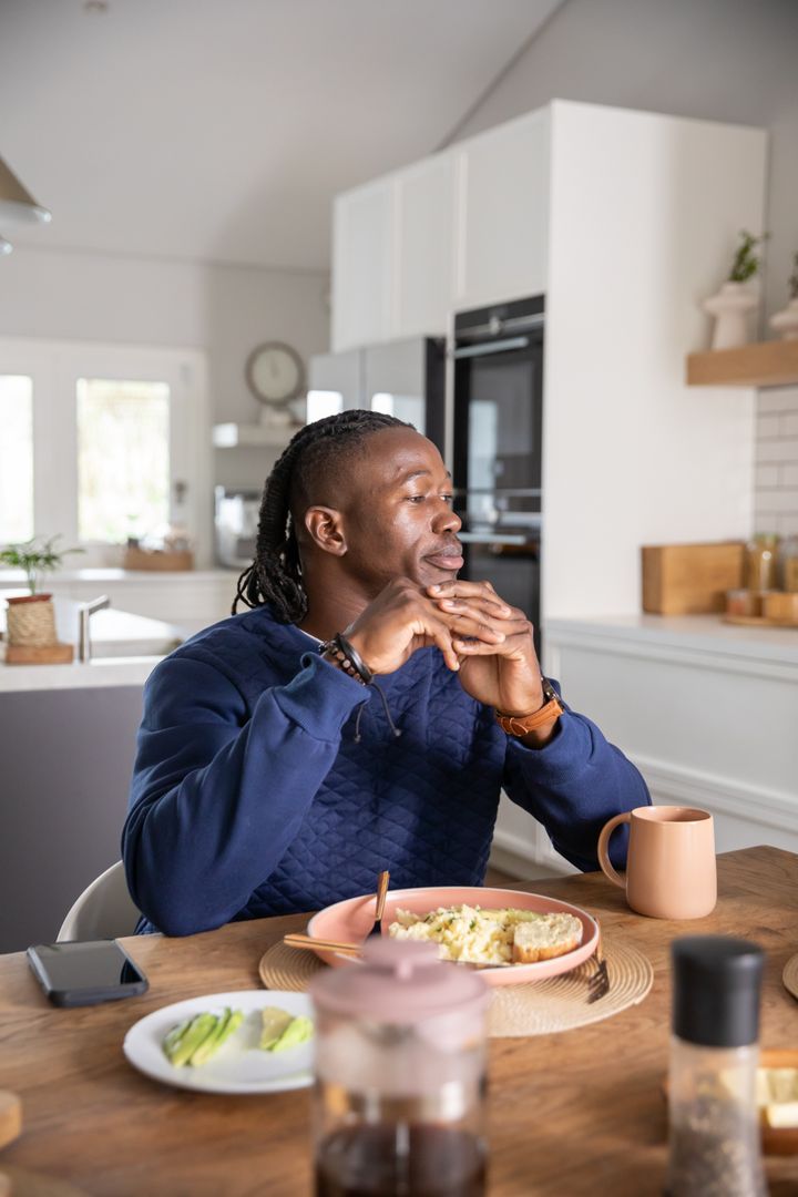 Man Enjoying Breakfast at Home in Modern Kitchen Ambiance