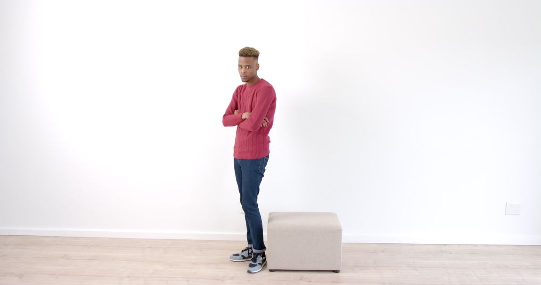 Man Standing with Arms Crossed in Minimalist Interior