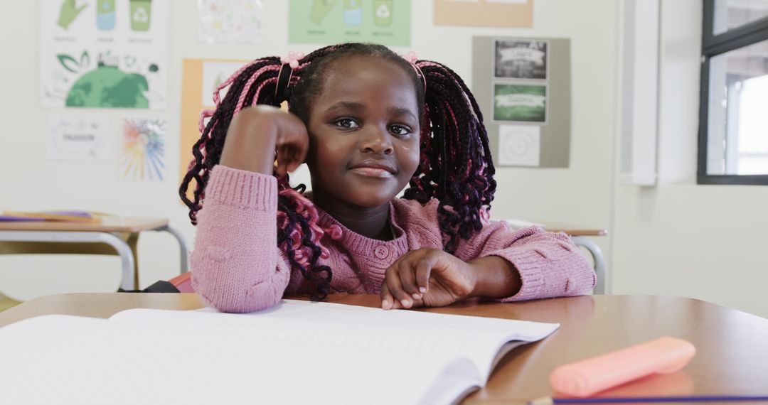 Young Student Highlighting Workbook in Eco-Friendly Classroom