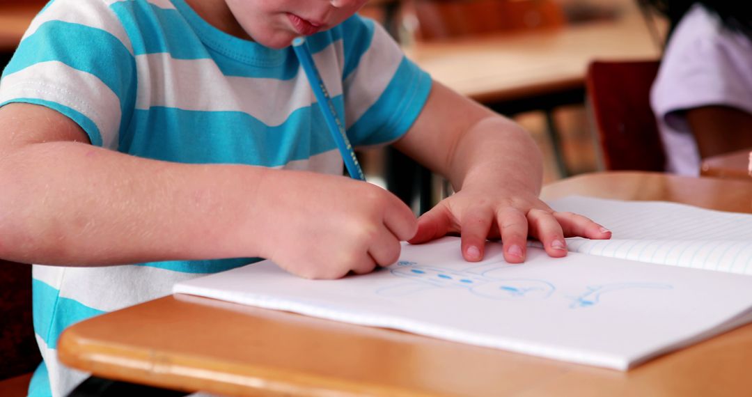 Young Child Concentrating on Drawing in School - Free Images, Stock Photos and Pictures on Pikwizard.com