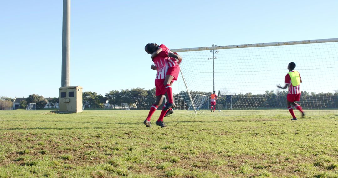 Dynamic Soccer Celebration: Athletes Embracing Victory on Field