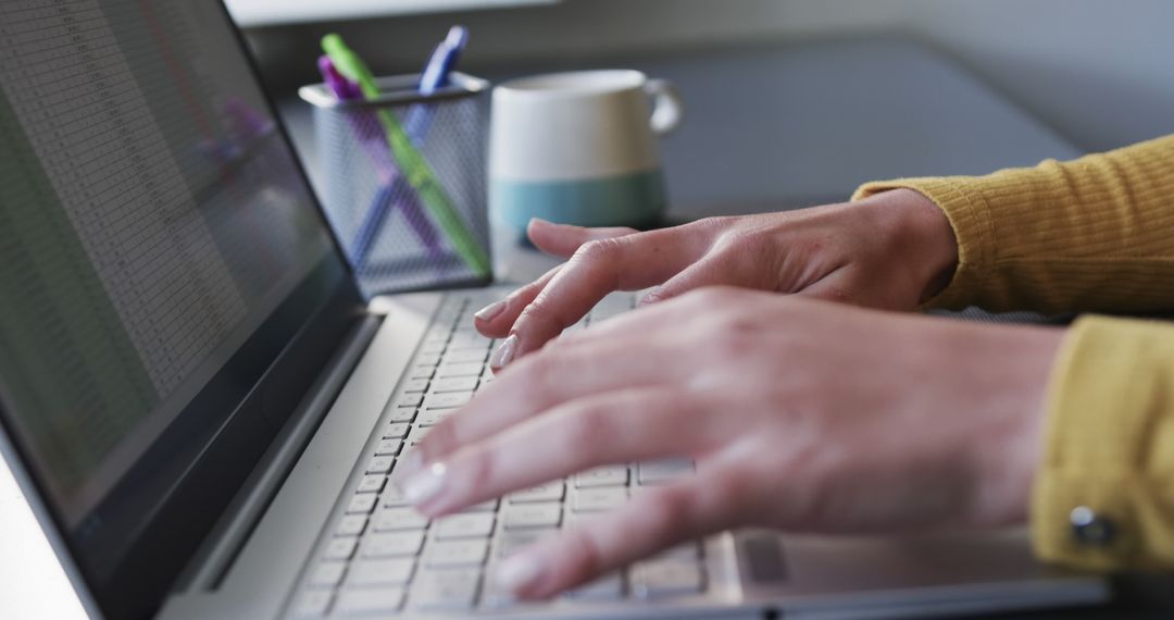 Young Professional Using Laptop for Remote Work