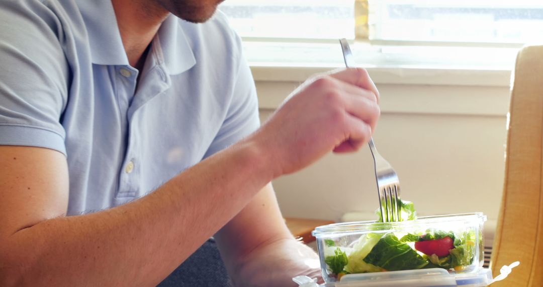 Man Eating Fresh Salad at Home - Free Images, Stock Photos and Pictures on Pikwizard.com