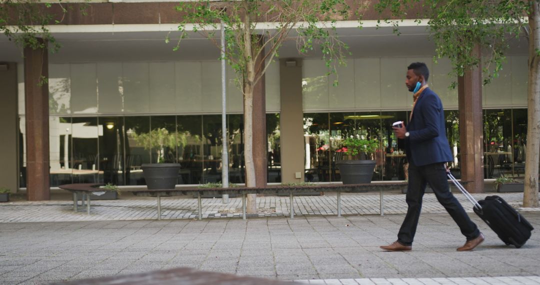 Businessman Walking with Luggage in Urban Environment - Free Images, Stock Photos and Pictures on Pikwizard.com