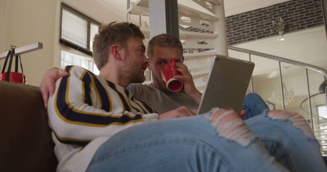 Happy Couple Relaxing at Home Using Digital Tablet