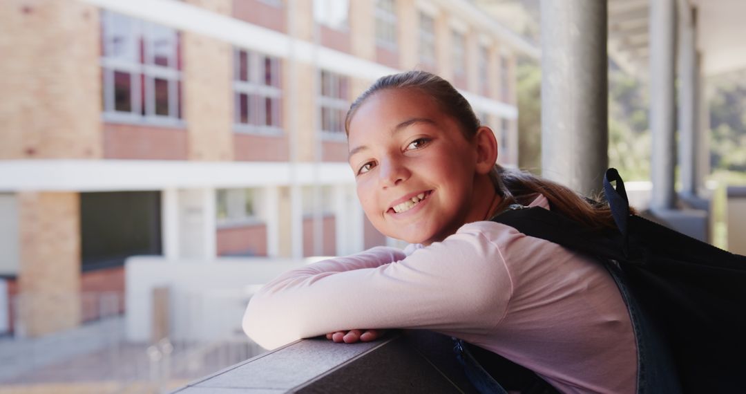 Smiling Student Relaxing During School Break on School Balcony