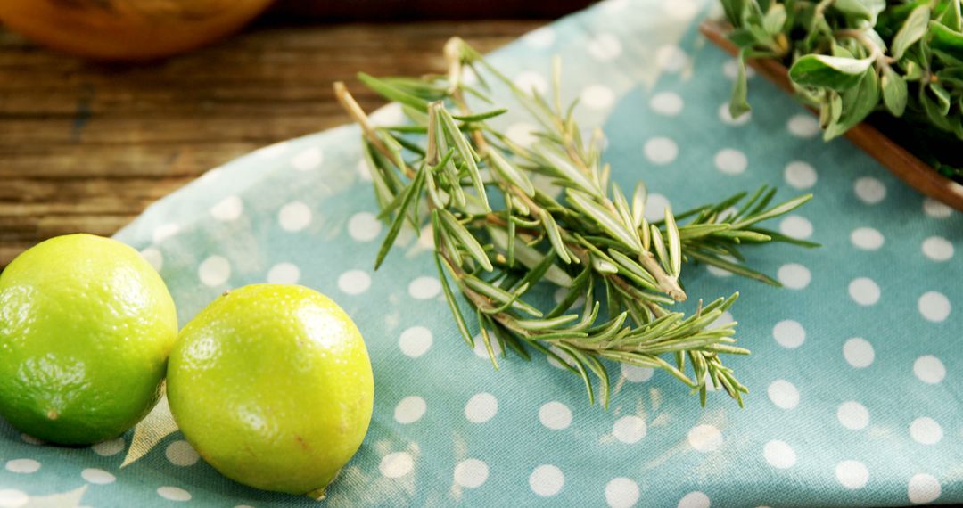 Fresh Rosemary and Limes on Polka Dot Fabric - Free Images, Stock Photos and Pictures on Pikwizard.com