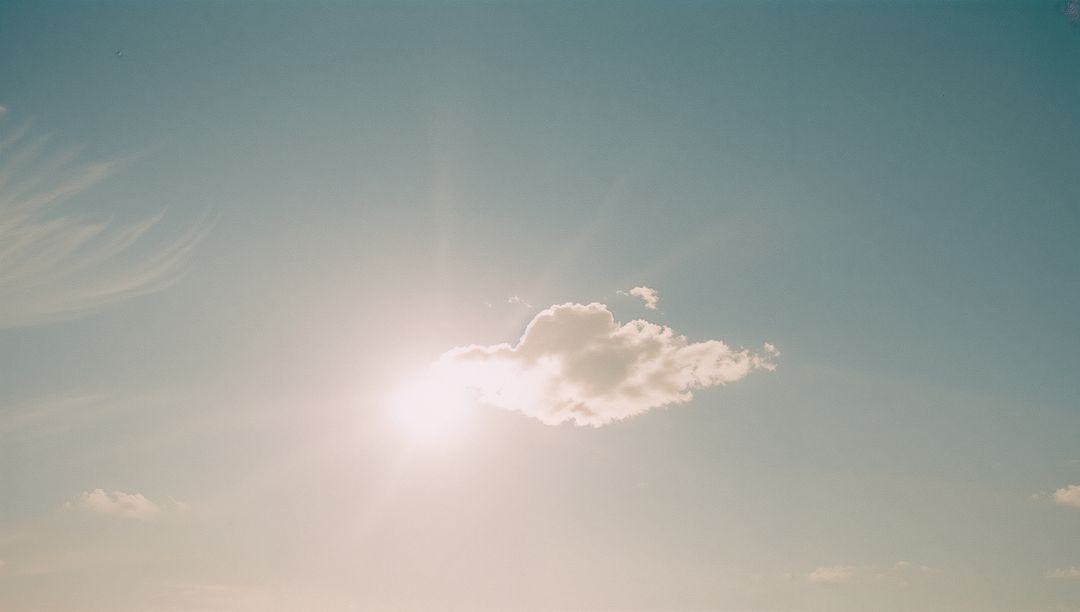 Cumulus Cloud Illuminated by Radiant Sun in Serene Sky