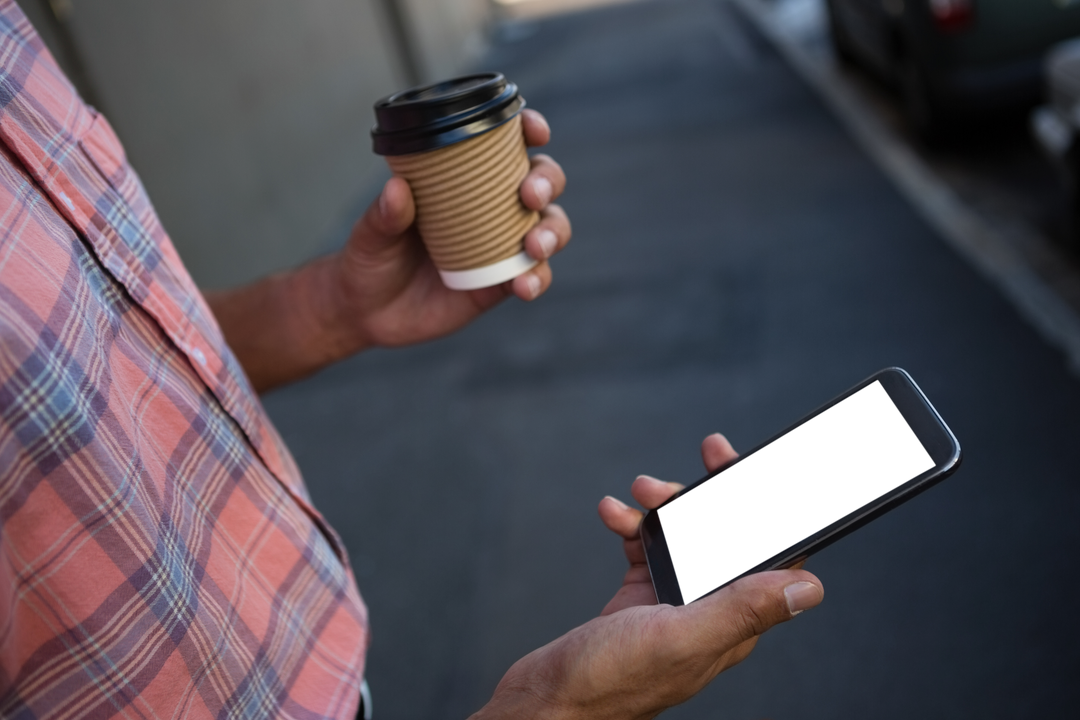 Midriff Holding Coffee and Transparent Smartphone Outdoors - Download Free Stock Images Pikwizard.com