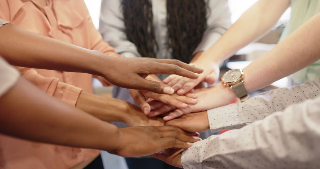 Diverse Team with Hands Together Symbolizing Unity and Collaboration - Free Images, Stock Photos and Pictures on Pikwizard.com