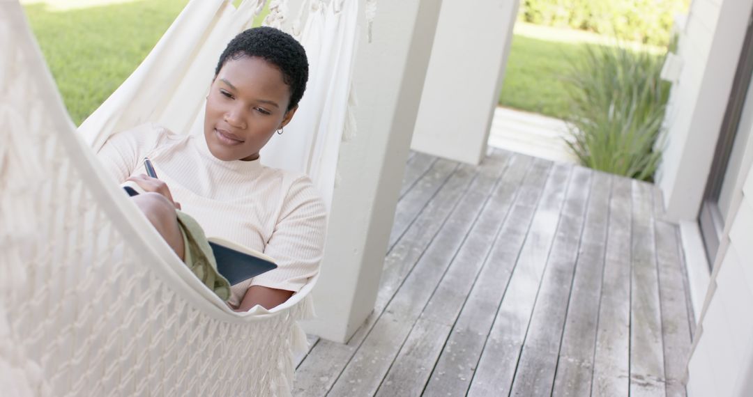 Relaxed Woman Journaling in Hammock on Porch - Free Images, Stock Photos and Pictures on Pikwizard.com