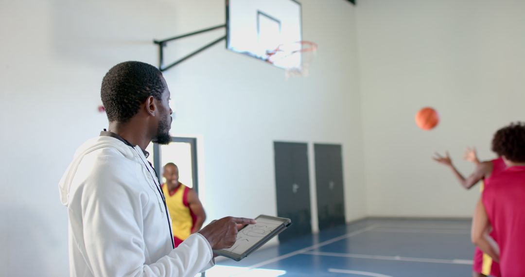 Basketball Coach Analyzing Player Performance Indoors