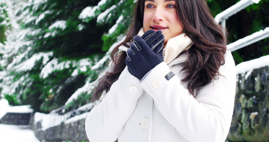 Woman in Warm Clothing Holding Hands in Snowy Winter - Free Images, Stock Photos and Pictures on Pikwizard.com