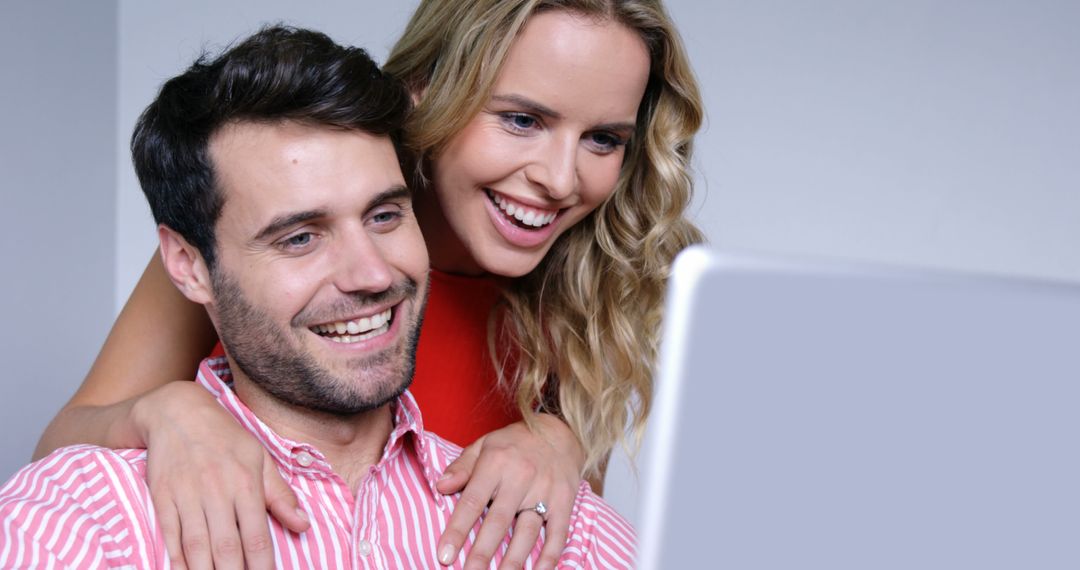 Happy Couple Excitedly Looking at Laptop Screen - Free Images, Stock Photos and Pictures on Pikwizard.com